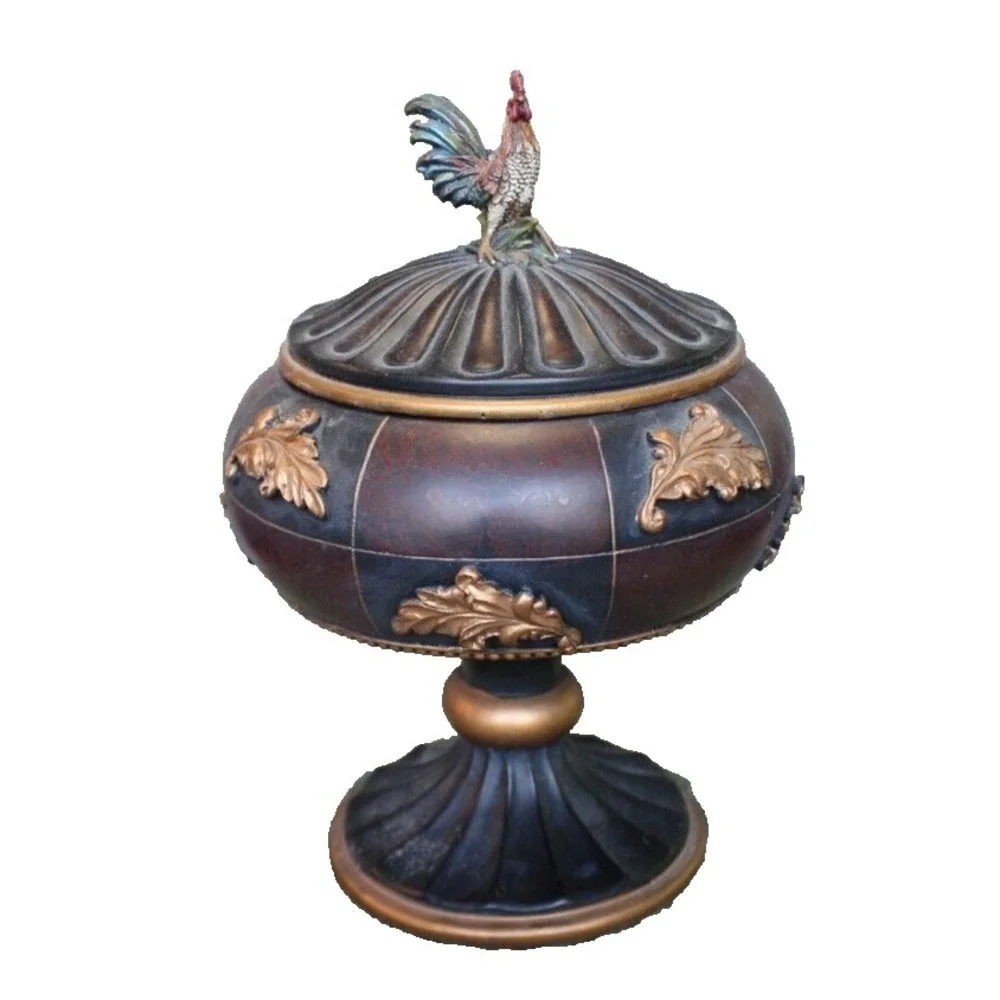 Notions container in form of large lidded pedestal cup with rooster on top